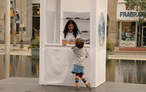 Woman in booth talking to child