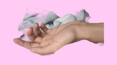 a digitally cropped hand with a soft blanket on a pink background