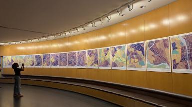 installation view of colourful maps of waterloo region on a convex wall