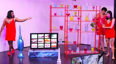 performance documentation of people dancing in a pink room with sculptural objects