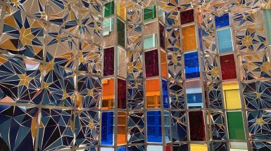 interior installation view with moquarnas pattern on thousands of painted shards and multicoloured plexiglass