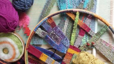 Image of coloured yarn on a circular cardboard loom.