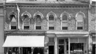 Black and white photo of historical storefront of White Rose cafe.