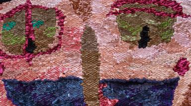 Weaving closeup. Mostly mottled pink skin, red ringed eyes, wide open semicircle mouth, long nose.