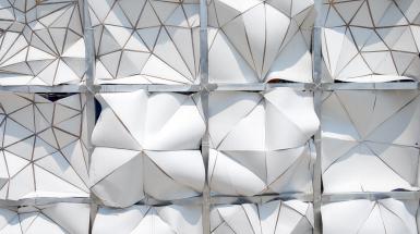 Geometric white backs of mosaic cloth panels.