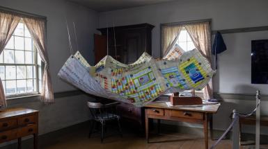 Hanging install of the teabag quilt.