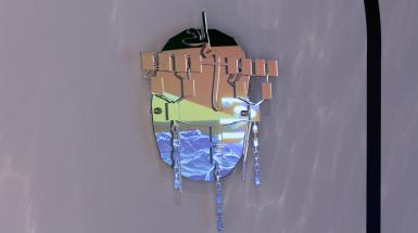 A mask made of mirror pieces, reflecting the nearby projected video screen.