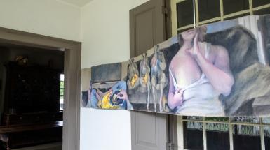 Long, undulating painting of many overlapping scenes.