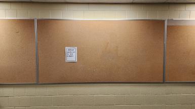 A poster that says "Seeking permission to take a break" alone on a cork board.
