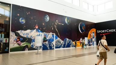 An alternate angle of a collage mountains with space behind them with multiple figures throughout