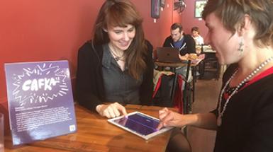Two Woman interacting with common web app on ipad. 