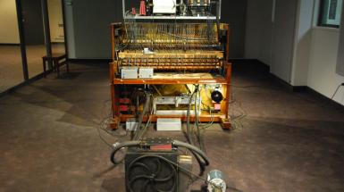 An open acoustic piano connected to tubes and wires.