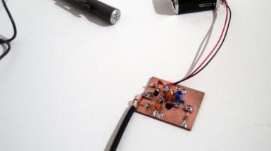 Small circuit board with battery and small speaker attached. 