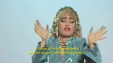 Woman with hands up with captions that say "a sense of kinship between woman across national boundaries"
