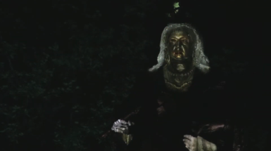 Image of Sculpture of a queen with a fave projected on.