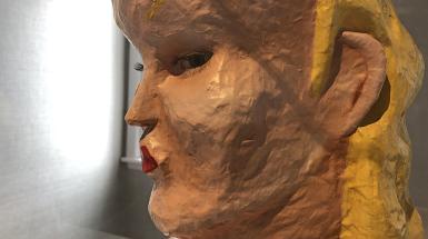 Paper mache of female figure. Looking through the side of her eye. view from side profile. 