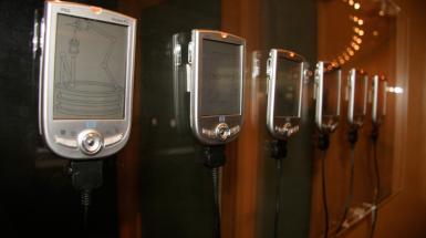a line of mounted "pocket PC" with different illustrative imagery on the screens.