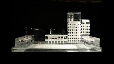 A architectural model of a building captured in an ice block. 