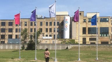 Photo of five flags outside google building 