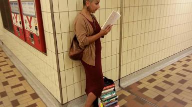 Individual reading book in subway station 