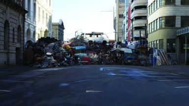 Image of a damn in a road made by various trash 