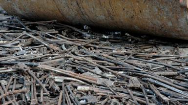 Photo of shotguns being crushed being steam rolled