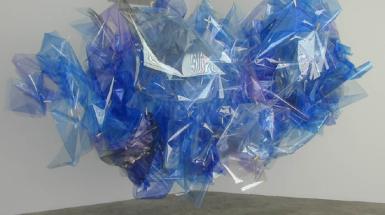 Sculpture of blue, purple and grey plastic sheets in cloud like shape