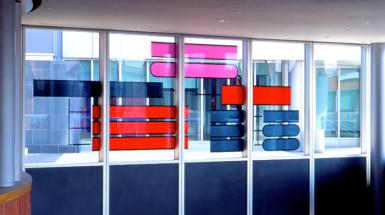 Windows with stain glass rectangles in colours red, magenta and dark grey.