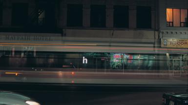 Motion blurred image of cars with small letter h on in center