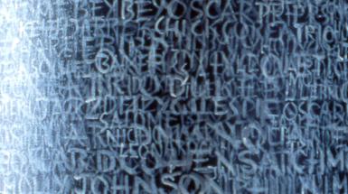 Layered handwritten language, symbols, and marks are a central motifs for this work which transforms a column into a work of art.