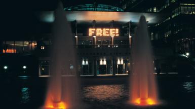 Image of Kitchener city hall with sign that says free using light bulbs