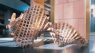 Large sculpture with vertical strips that hold large balls
