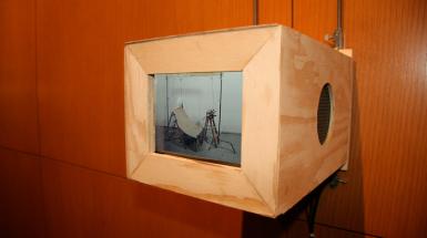 a wooden box with video of chair like structure 
