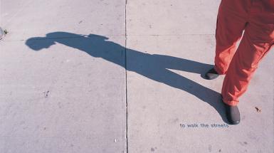 legs with shadow of human and small text that says "to walk the street"
