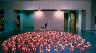 Red solo cups connected by electrical wires to a chair