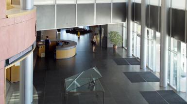VIew looking down at steel anvil holding apart two large glass slabs 