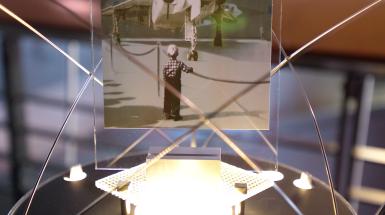 Postcard of little boy looking at plane on stand