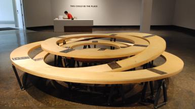 Multiple wooden circles inserted inside each other some of tilter 