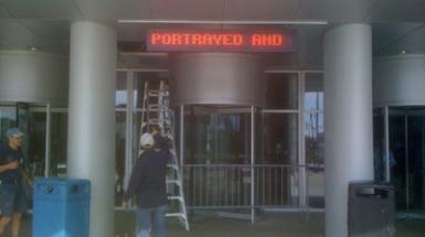 LED sign that reads "portrayed and"