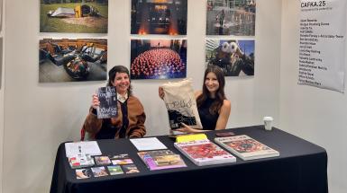CAFKA staff at a booth at Art Toronto holding up merch