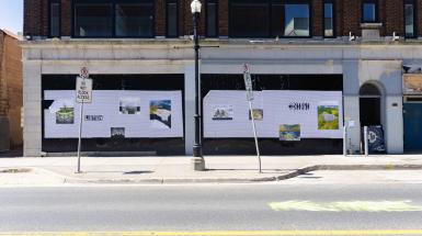 A wheatpasted billboard on a building facade