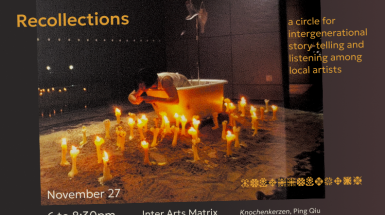 Image of bone candles burning atop sand, with an artist in a clawfoot bathtub, IV bags hanging behind.