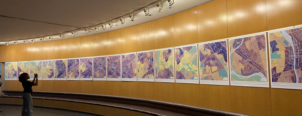 installation view of colourful maps of waterloo region on a convex wall