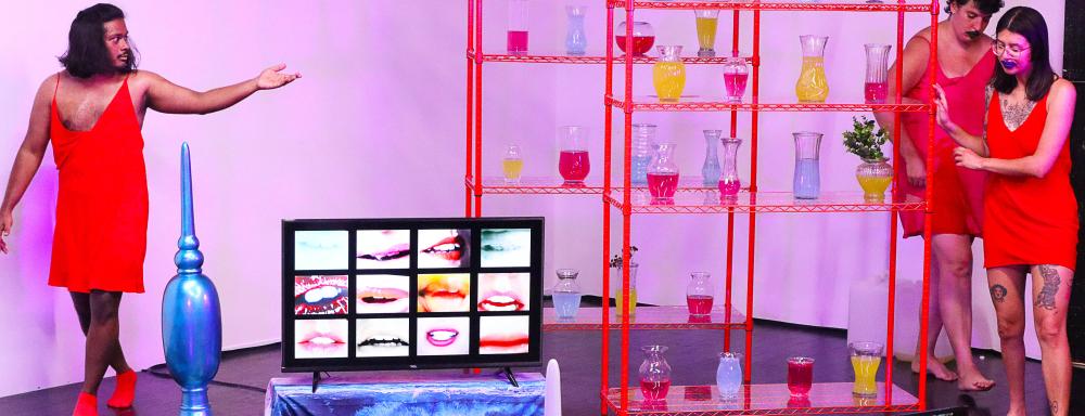 performance documentation of people dancing in a pink room with sculptural objects