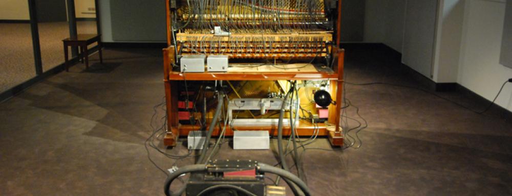 An open acoustic piano connected to tubes and wires.