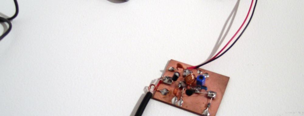 Small circuit board with battery and small speaker attached. 