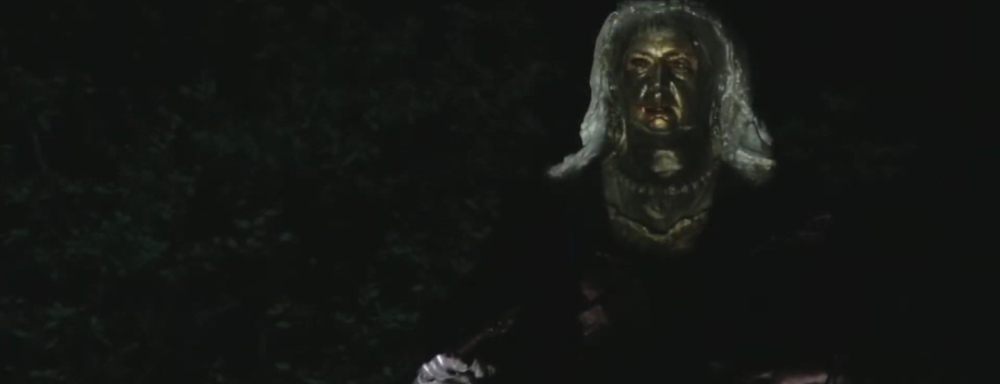 Image of Sculpture of a queen with a fave projected on.