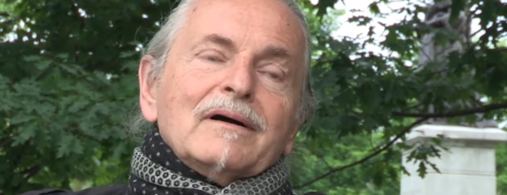 image of artist Kryzysztof Wodiczko talking about his work. 