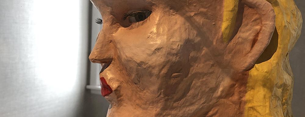 Paper mache of female figure. Looking through the side of her eye. view from side profile. 