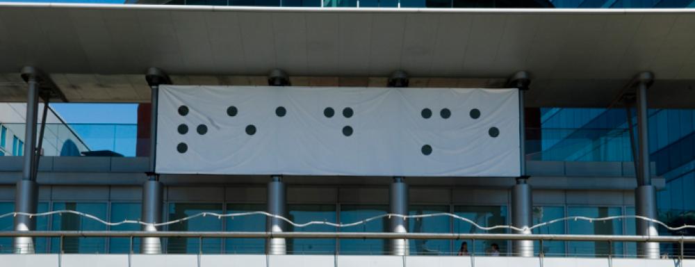 Banner on Kitchener city hall which feature braille with tactile element removed.